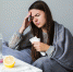 woman-on-couch-with-medication - ИА МедиаПоток